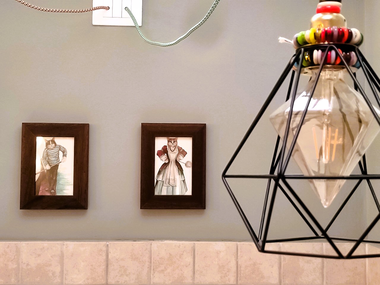 La Serenissima kitchen detail — Venetian cat artworks and geometric pendant lamp