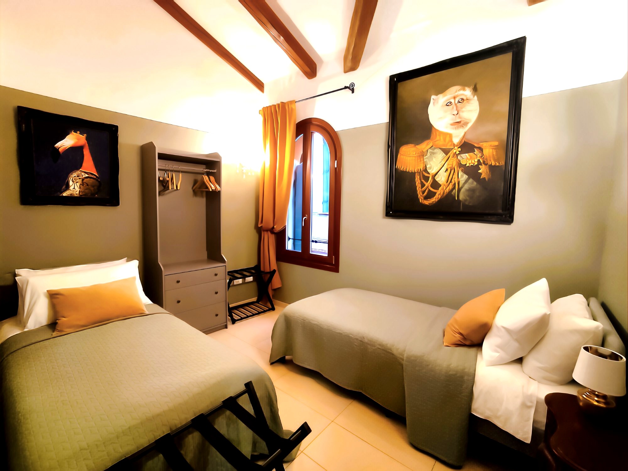 La Serenissima second bedroom with wooden beams and artworks