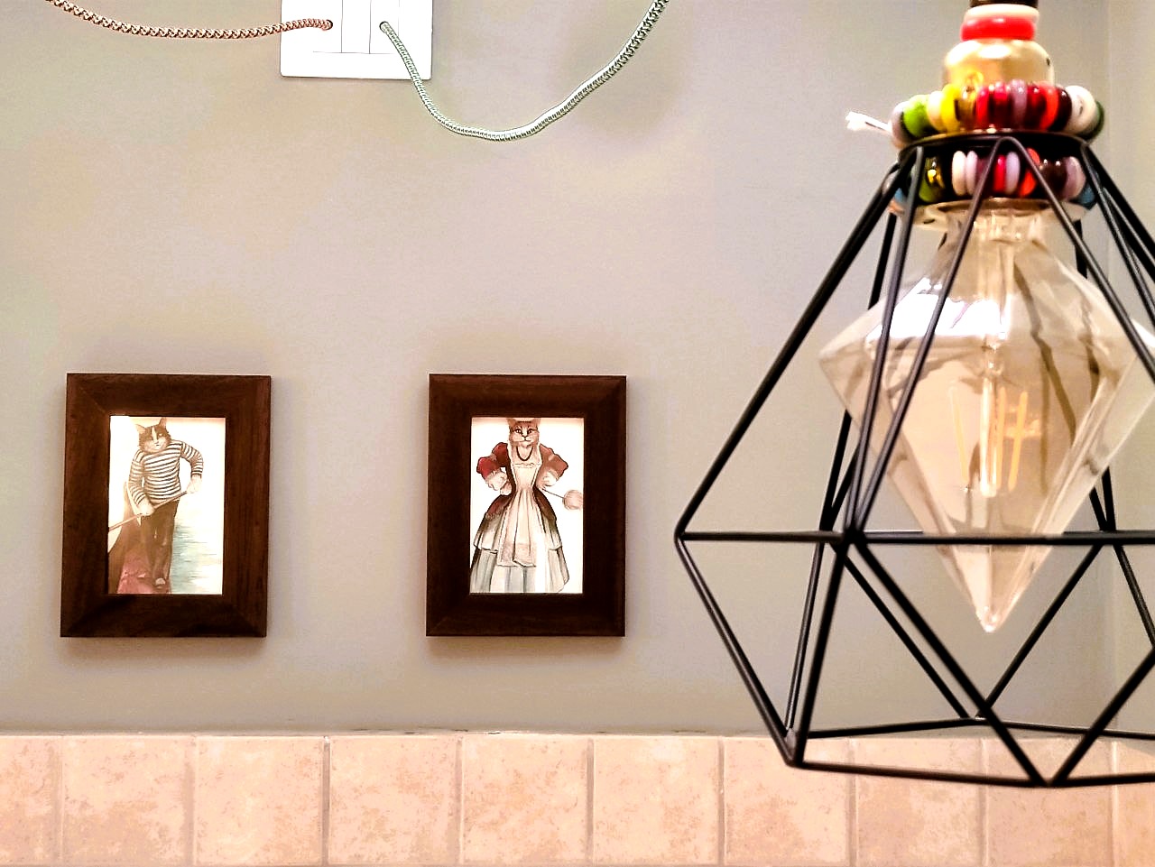 La Serenissima kitchen detail — Venetian cat artworks and geometric pendant lamp